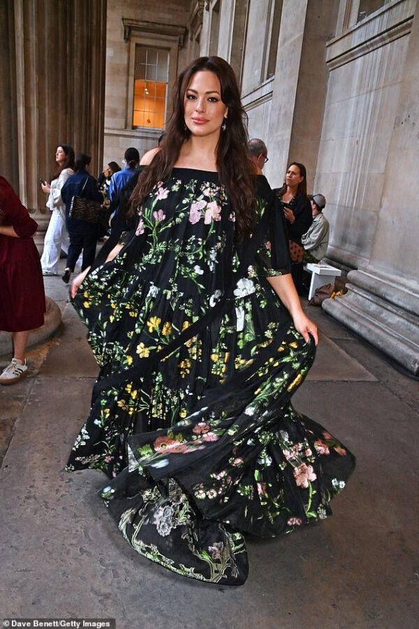 Ashley Graham puts on a playful display as she spins around in a floral maxi dress at the LFW Erdem show