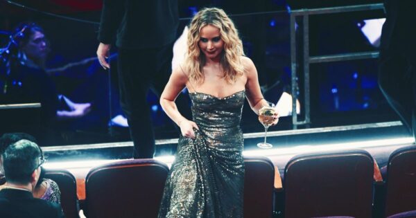 Jennifer Lawrence Accessorizes With Wine Glass at the Oscars