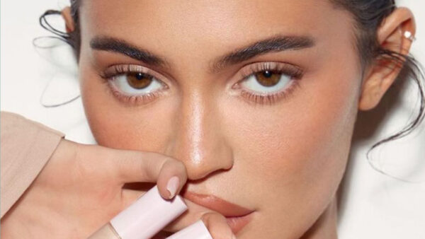 Kylie Jenner shows off her real eyelashes and messy hair bun as she pouts for the camera for new concealer ad