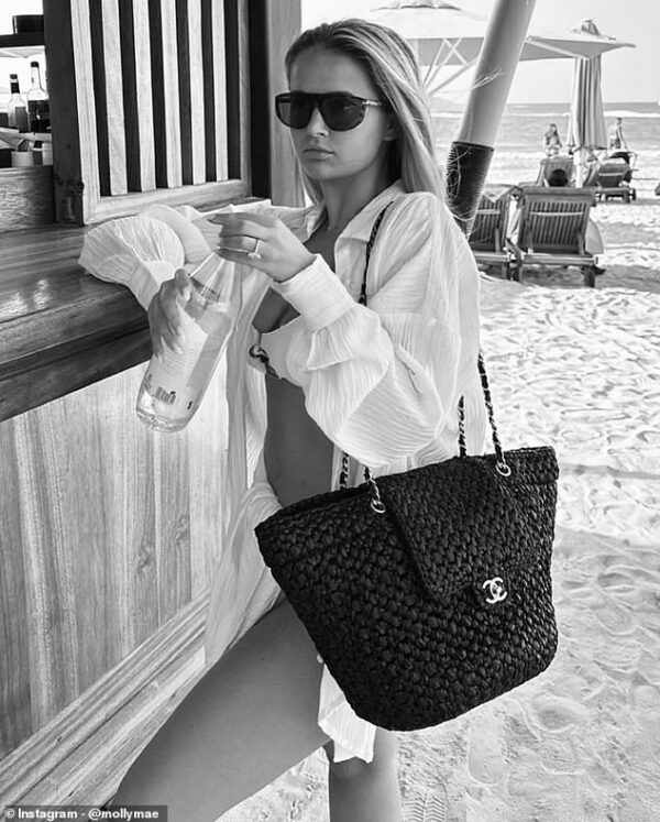 Molly-Mae Hague brings her £10,000 Chanel bag to the beach before slipping into a figure-hugging red dress as she shares more snaps from luxury Dubai break