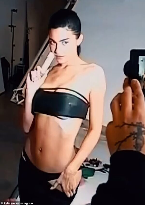 Kylie Jenner shows off her sculpted physique in black leather bandeau top and matching panties as she shares BTS snaps from her sizzling cosmetics shoot