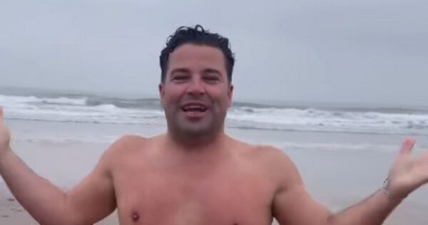 X Factor's Joe McElderry looks unrecognisable as he strips off in beach video