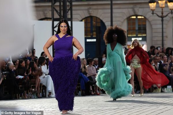 Ashley Graham wears quirky furry purple dress and bold 70s makeup as she walks the runway at Vogue World Paris