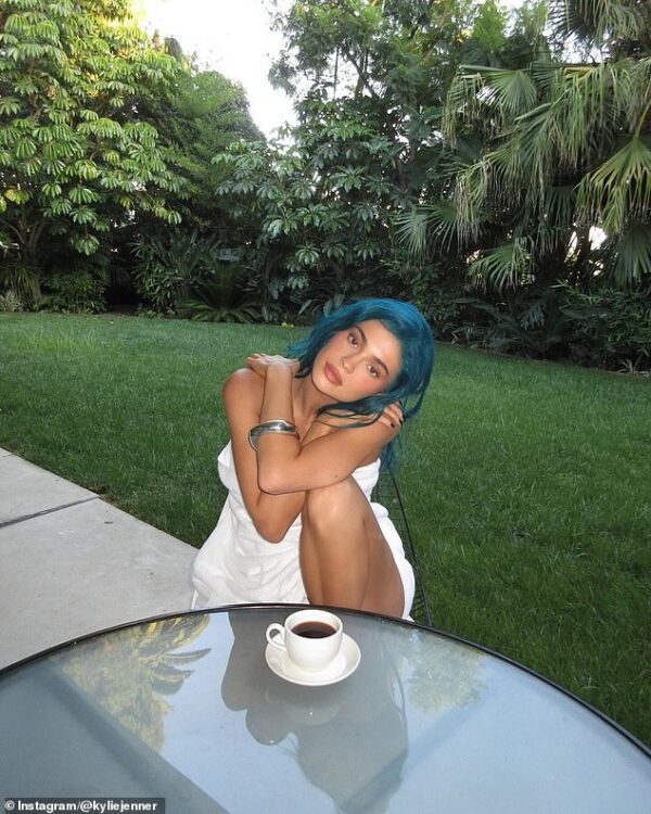 Kylie Jenner almost spills out of her towel as she shows off her new blue hair while enjoying a cup of coffee